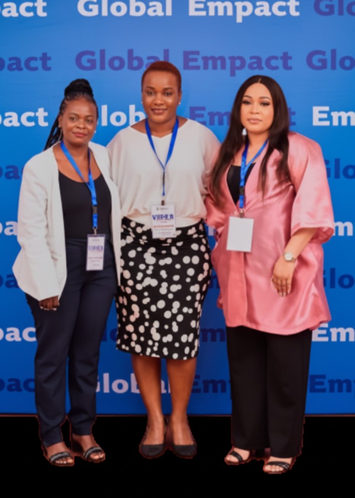 Three Global Empact women leaders standing together at an event